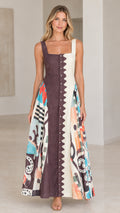 Front view of model wearing chocolate brown and cream scalloped button-front maxi dress with abstract print skirt