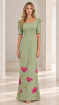 Front full view of woman wearing sage green square neck maxi dress with floral embroidery