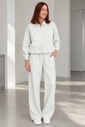 Front view of woman wearing Heather Grey collared zip-up lounge set with wide-leg pants