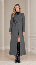Front full-length view of model wearing a Charcoal Grey belted maxi overcoat with black boots
