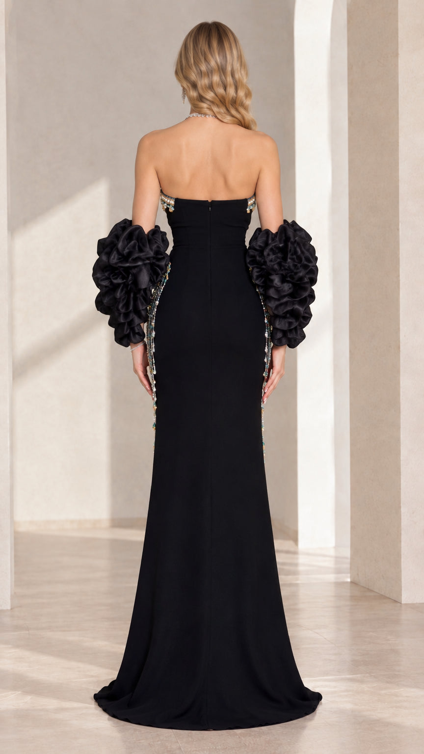 Back view of black strapless floor-length evening dress