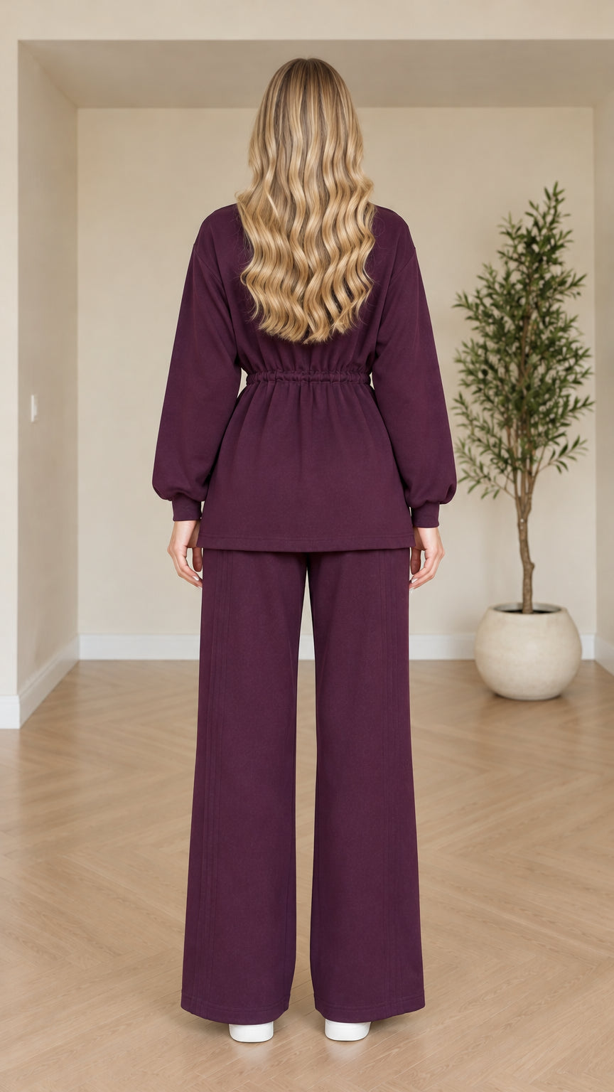 Back view of model in plum drawstring top and wide-leg lounge pants