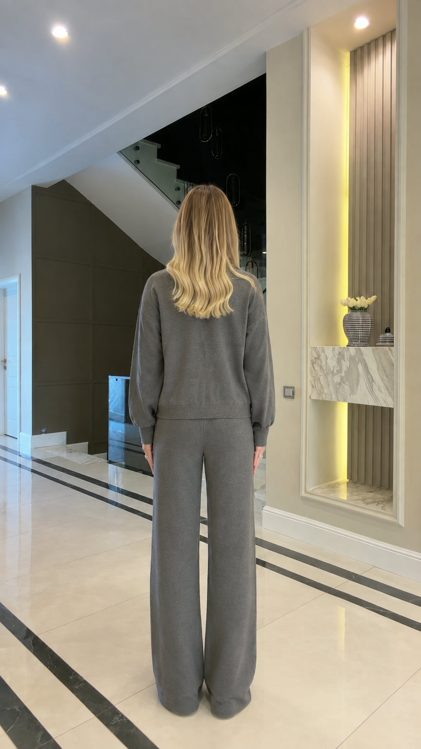 Back full view of woman wearing charcoal grey two-piece tracksuit set