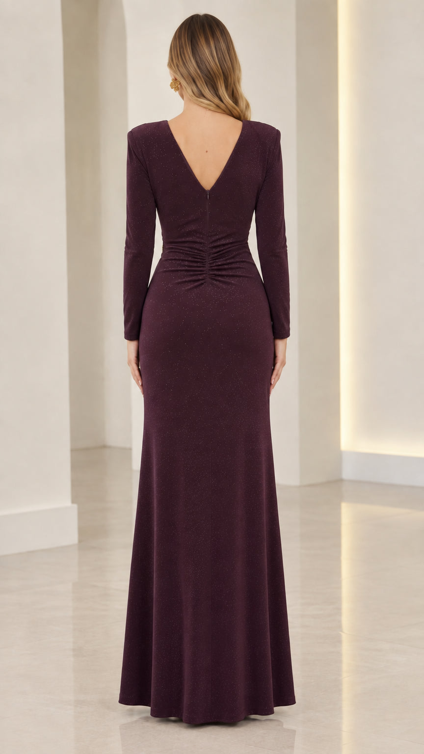 Back view of model showing V-back and ruching on plum maxi formal dress