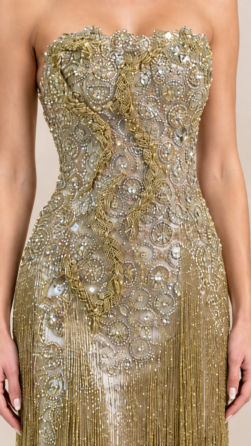 Close-up detail of ornate beadwork, sequins, and fringe on bodice
