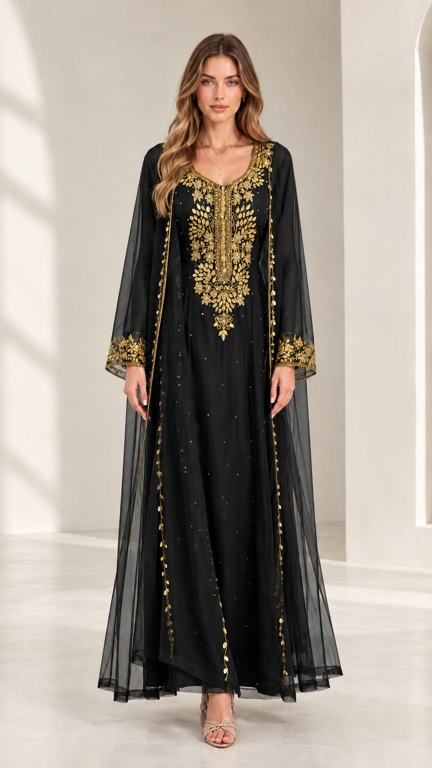 Front view of woman wearing black embroidered kaftan maxi dress with gold accents
